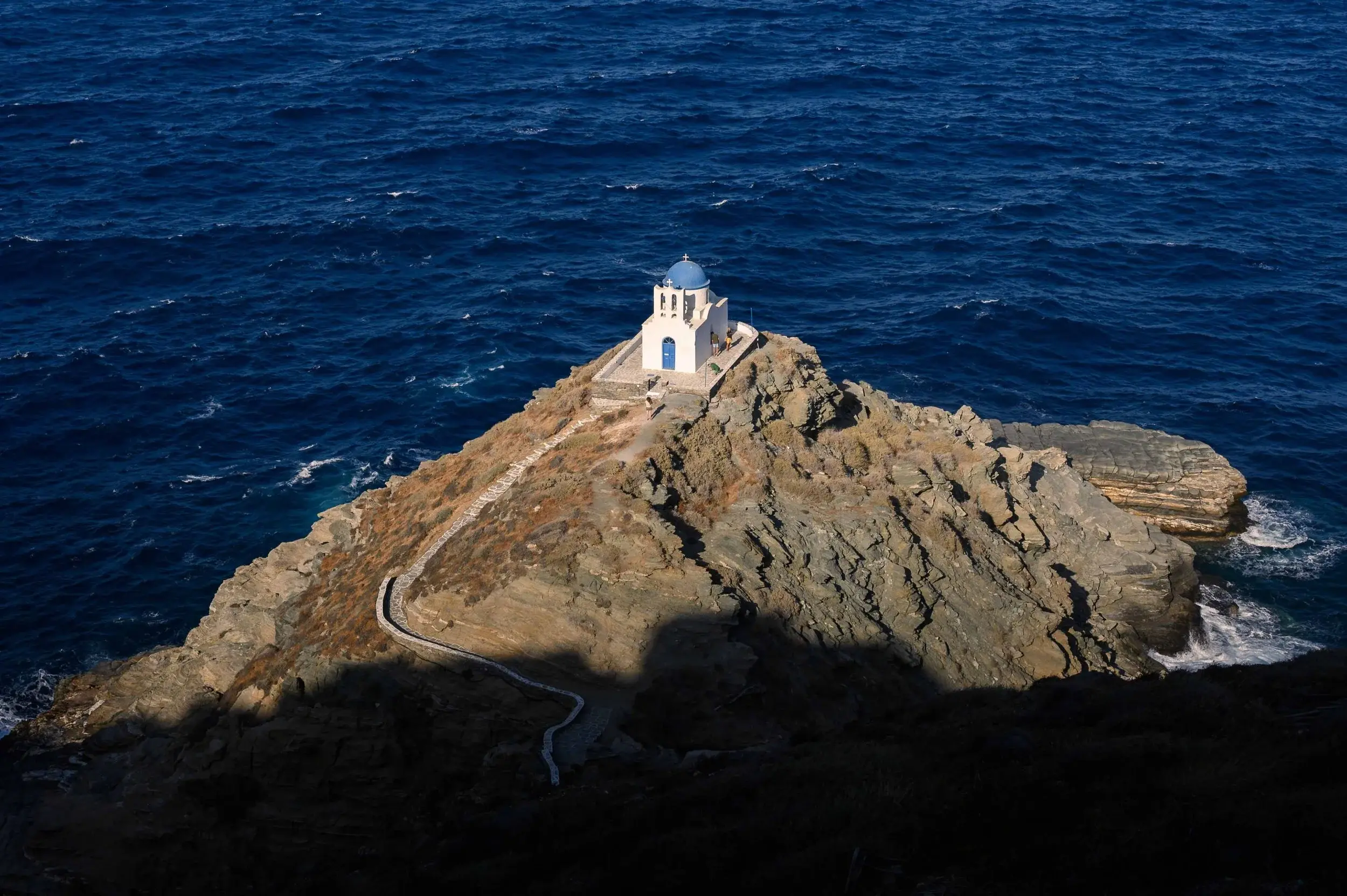 The white church of the Seven Martyrs on its rocky outcrop below Kastro